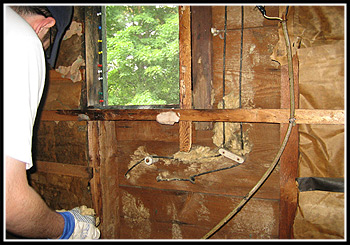 Insulation removal to expose Knob & Tube Wiring which will be removed.